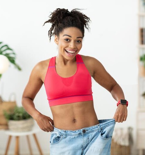 excited-woman-wearing-too-big-jeans- lose weight